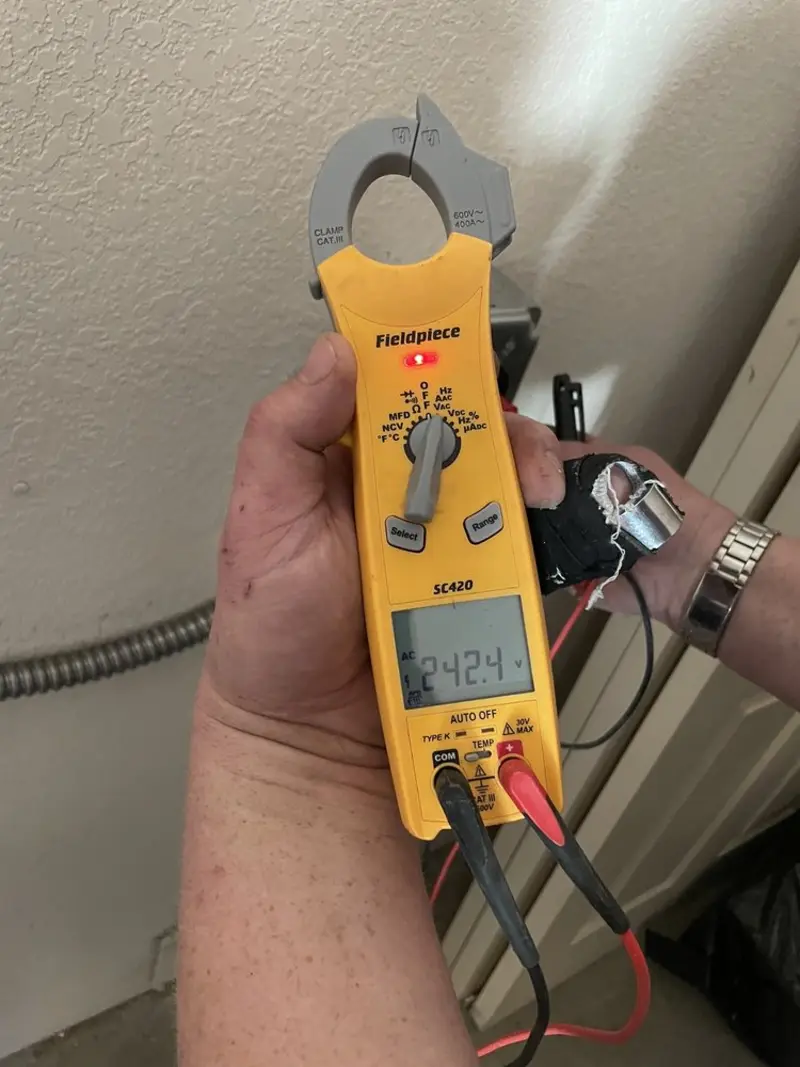 Voltage testing with clamp meter during Whole House Surge Protector in Center